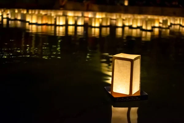 Image of Paper Lanterns on Water as Asian evening event for festivity and celebration