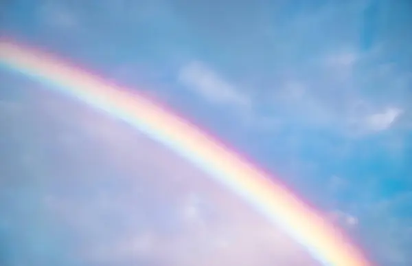 Image of Beautiful rainbow in sky exposing full range of colors as diversity and art