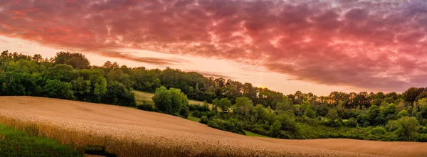sunset in countryside with red clouds and sky