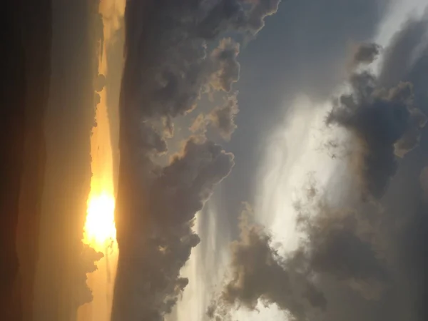 Sunset over the sea with clouds and rays of light through the clouds