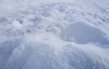 Close up white snowdrifts in sunny winter day