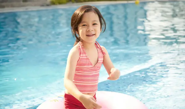 Smiling Young Girl Striped Swimsuit Swim Ring Enjoying Pool Sunny Stock Image