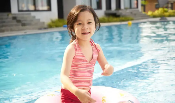 Smiling Young Girl Striped Swimsuit Swim Ring Enjoying Pool Sunny Stock Photo