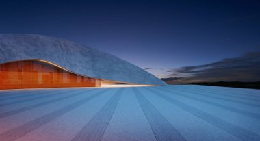 Günbatımında beton ve cam cepheli modern bir binanın önündeki boş otopark.