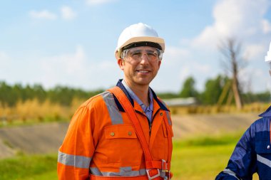 Technician working outdoor at wind turbine field. Environmental engineer research and develop approaches to providing clean energy sources