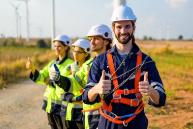Technician working outdoor at wind turbine field. Environmental engineer research and develop approaches to providing clean energy sources