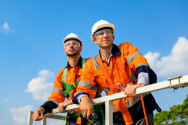 Technician working outdoor at wind turbine field. Environmental engineer research and develop approaches to providing clean energy sources