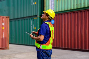 Warehouse engineer worker working at container yard. Logistics and Transportation. High quality photo