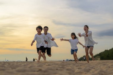 Happy Asian family travel together on beach on holiday. Family with beach travel. People enjoying with holiday vacation. High quality photo
