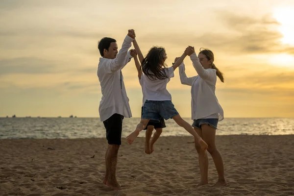 Happy Asian family travel together on beach on holiday. Family with beach travel. People enjoying with holiday vacation. High quality photo