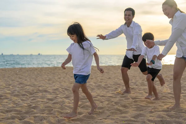Happy Asian family travel together on beach on holiday. Family with beach travel. People enjoying with holiday vacation. High quality photo