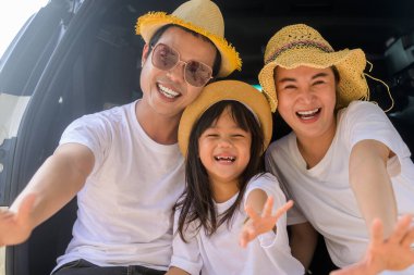 Happy Asian family travel together on beach on holiday. Family with beach travel. People enjoying with holiday vacation. High quality photo