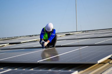 Professional technicians installing solar panels on rooftop of plant, Workers checking and operating system at solar cell farm power plant, Renewable energy source for electricity and power, Solar