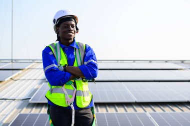Smiling portrait of happy engineer technician working on rooftop of solar cell farm power plant, Renewable energy source for electricity and power, Solar cell maintenance concept