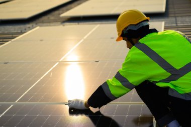 Professional engineer technician with safety helmet checking and operating system at solar cell farm power plant, Renewable energy source for electricity and power, Solar cell maintenance concept