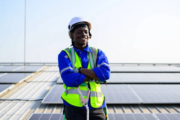 Smiling portrait of happy engineer technician working on rooftop of solar cell farm power plant, Renewable energy source for electricity and power, Solar cell maintenance concept