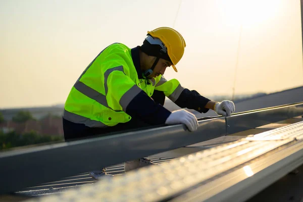 Worker with safety helmet checking and operating system at solar cell farm power plant, Renewable energy source for electricity and power, Solar cell maintenance concept