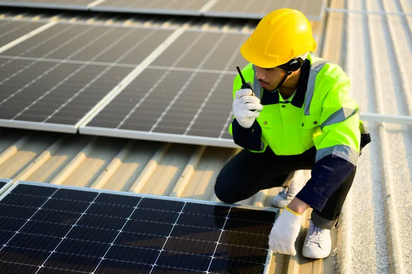 Engineer and technician checking and operating solar panels system on rooftop of solar cell farm power plant, Renewable energy source for electricity and power, Solar cell maintenance concept