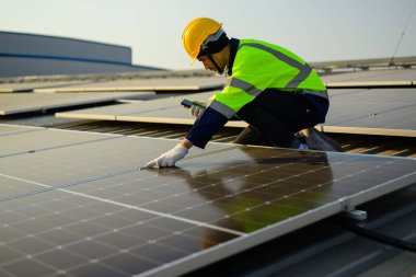 Professional engineer technician with safety helmet checking and operating system at solar cell farm power plant, Renewable energy source for electricity and power, Solar cell maintenance concept
