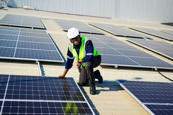 Professional engineer technician with safety helmet checking and operating system at solar cell farm power plant, Renewable energy source for electricity and power, Solar cell maintenance concept