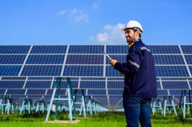 Engineer worker portrait with solar panel at solar farm, Solar farm with engineer workers analyzing solar cell, Renewable energy engineers work production of energy renewable or sustainable source