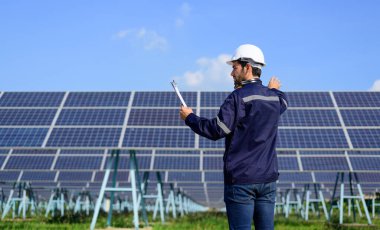 Engineer worker portrait with solar panel at solar farm, Solar farm with engineer workers analyzing solar cell, Renewable energy engineers work production of energy renewable or sustainable source