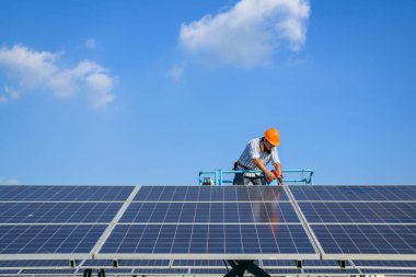 Solar panel station, Engineer worker installing solar panel at solar energy farm field, Alternative energy