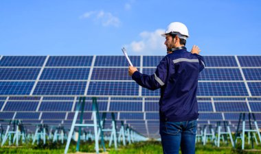 Engineer worker portrait with solar panel at solar farm, Solar farm with engineer workers analyzing solar cell, Renewable energy engineers work production of energy renewable or sustainable source