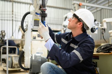 Engineer technician controlling robotic arms on computer laptop, Software mechanic control machine