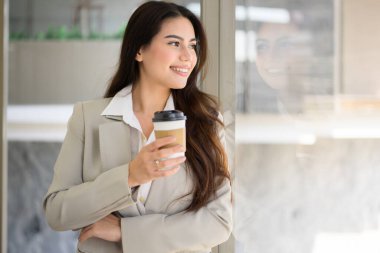 Confident businesswoman with cup of coffee at office, Profession female manager drinking coffee with happiness, High quality photo