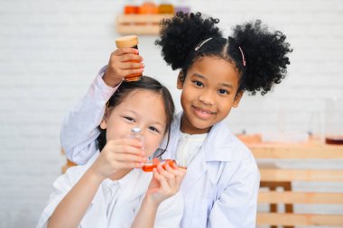 Back to school, Kids education knowledge, Child in classroom at school, Kid dressed Science lab coat. Science concept