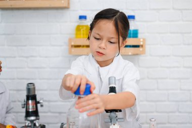 Back to school, Kids education knowledge, Child in classroom at school, Kid dressed Science lab coat. Science concept