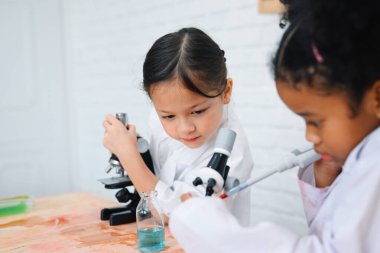Back to school, Kids education knowledge, Child in classroom at school, Kid dressed Science lab coat. Science concept
