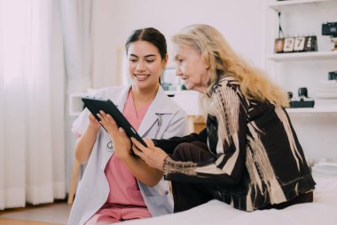 Professional doctor explaining prescription to senior patient at home visit, People with health care service at home