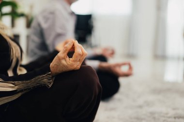 Close up hands of senior couple sitting in living room with yoga exercise, Retirement people resting and relaxing at home