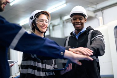 Engineer mechanician operating and controlling CNC machine at innovation factory
