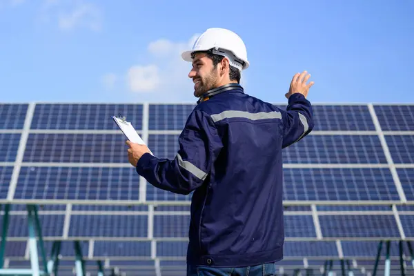 Engineer worker portrait with solar panel at solar farm, Solar farm with engineer workers analyzing solar cell, Renewable energy engineers work production of energy renewable or sustainable source