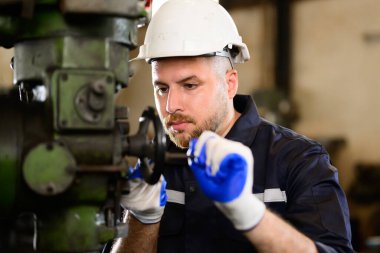 Professional worker of manufacturing plant factory, Engineer working with machine, Maintenance machine, Mechanical engineering portrait