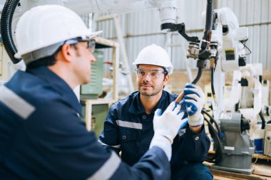 Engineer technician controlling robotic arms on computer laptop, Software mechanic control machine
