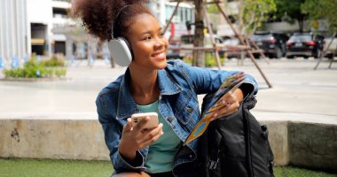 Portrait of smiling happy woman walking in street with backpack, Young tourist travel in city, Curly hair, Attractive, Summer vacation, Traveler, Cheerful, Positive, High quality photo