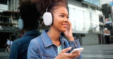 Portrait of smiling happy woman walking in street with backpack, Young tourist travel in city, Curly hair, Attractive, Summer vacation, Traveler, Cheerful, Positive, High quality photo