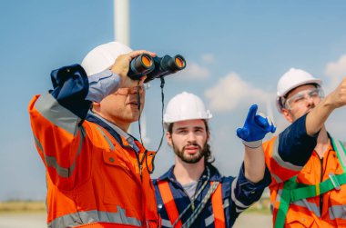 Professional engineer technician working outdoor at wind turbine field, Environmental engineer researching and developing clean energy sources, Green ecological power energy generation wind