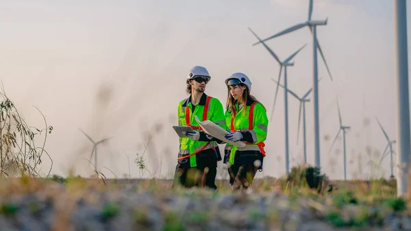 Professional engineer technician working outdoor at wind turbine field, Environmental engineer researching and developing clean energy sources, Green ecological power energy generation wind