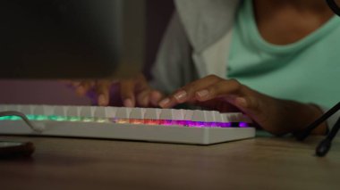 Professional game streamer using pc setup playing game talking on headset while explaining gameplay to subscribers, Teenager streaming online action game while sitting on chair, High quality photo