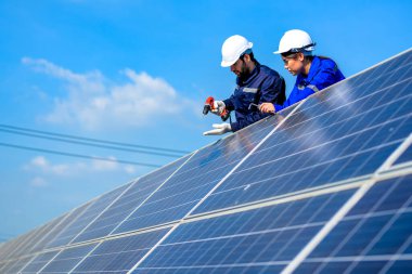 Solar panel station, Engineer worker installing solar panel at solar energy farm field, Alternative energy