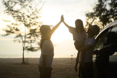 Happy Asian family travel together on beach on holiday. Family with beach travel. People enjoying with holiday vacation. High quality photo