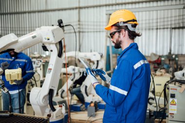 Engineer technician controlling robotic arms on computer laptop, Software mechanic control machine