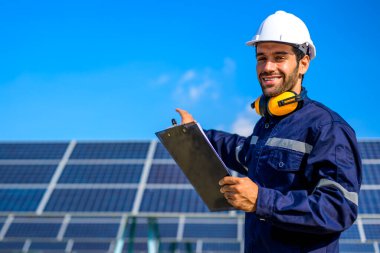 Engineer worker portrait with solar panel at solar farm, Solar farm with engineer workers analyzing solar cell, Renewable energy engineers work production of energy renewable or sustainable source