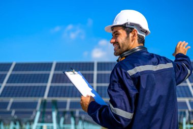 Engineer worker portrait with solar panel at solar farm, Solar farm with engineer workers analyzing solar cell, Renewable energy engineers work production of energy renewable or sustainable source