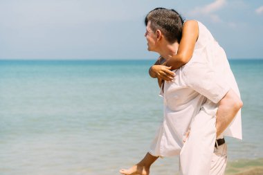 Romantic couple embracing together on beach, Man and woman enjoying with honeymoon trip at beach